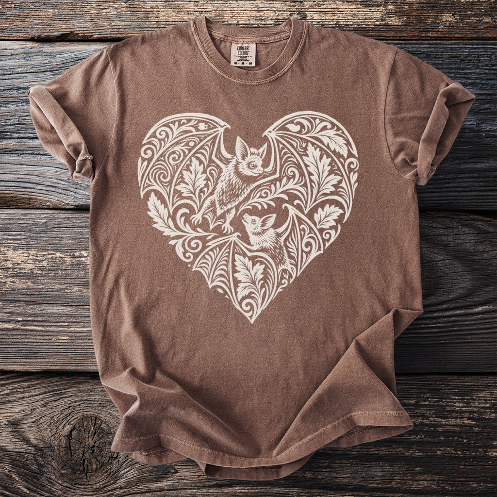 Brown t-shirt with a white heart-shaped bat and floral design.
