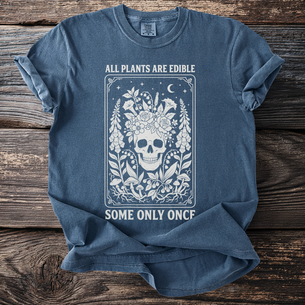 Blue t-shirt with white skull floral design and text: All Plants Are Edible Some Only Once