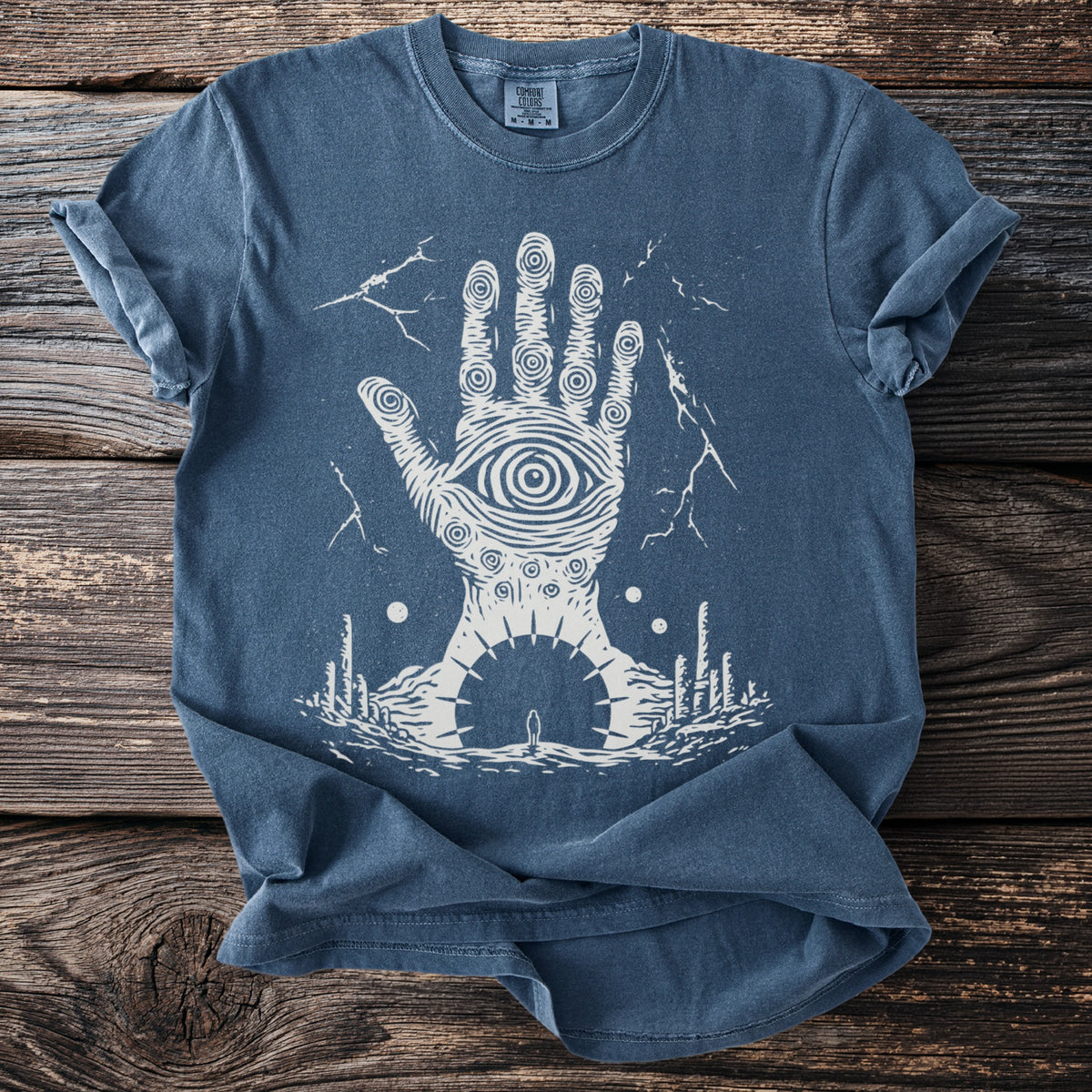 Blue t-shirt with a white graphic of a hand with an eye in the palm.