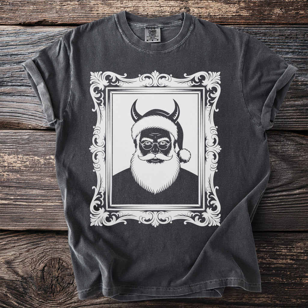 Dark t-shirt with distressed graphic of a devilish Santa Claus in an ornate frame.