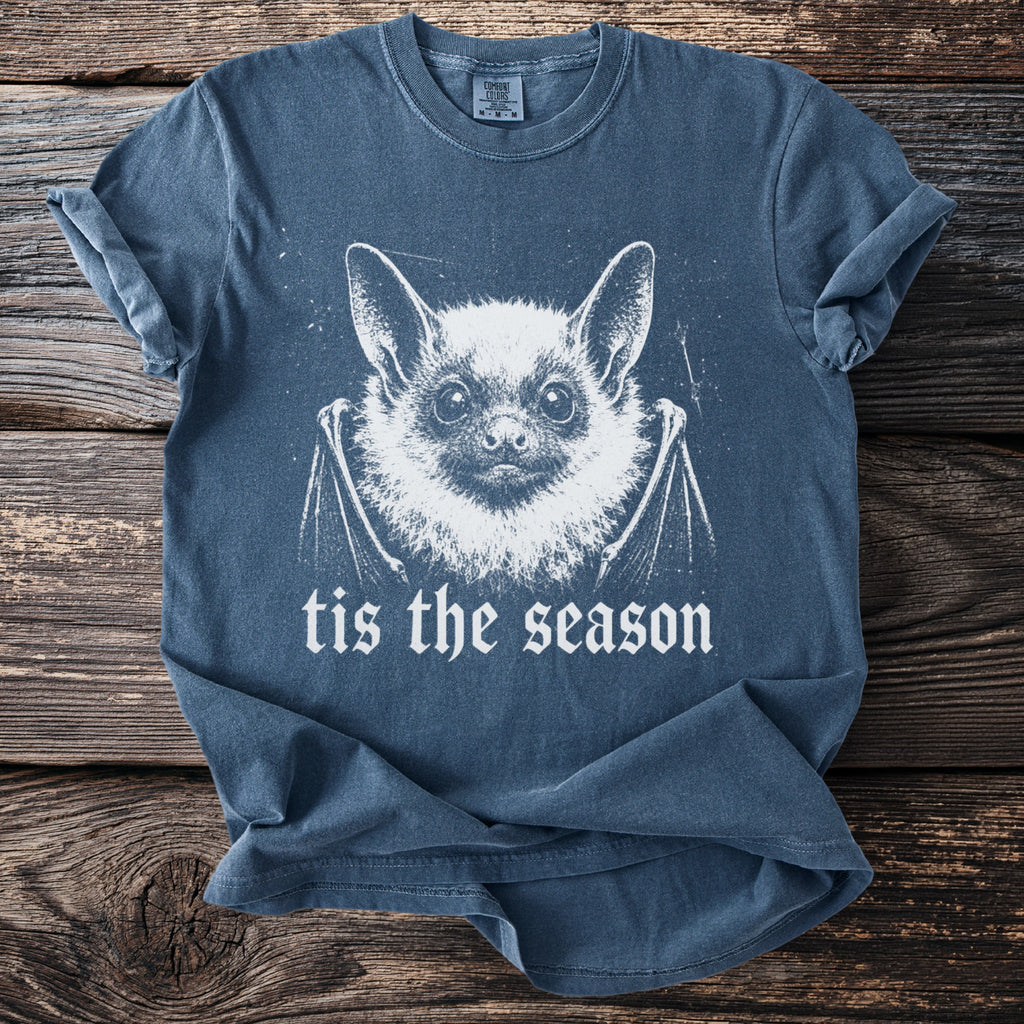 Blue short-sleeve t-shirt with a white bat graphic and "tis the season" text.