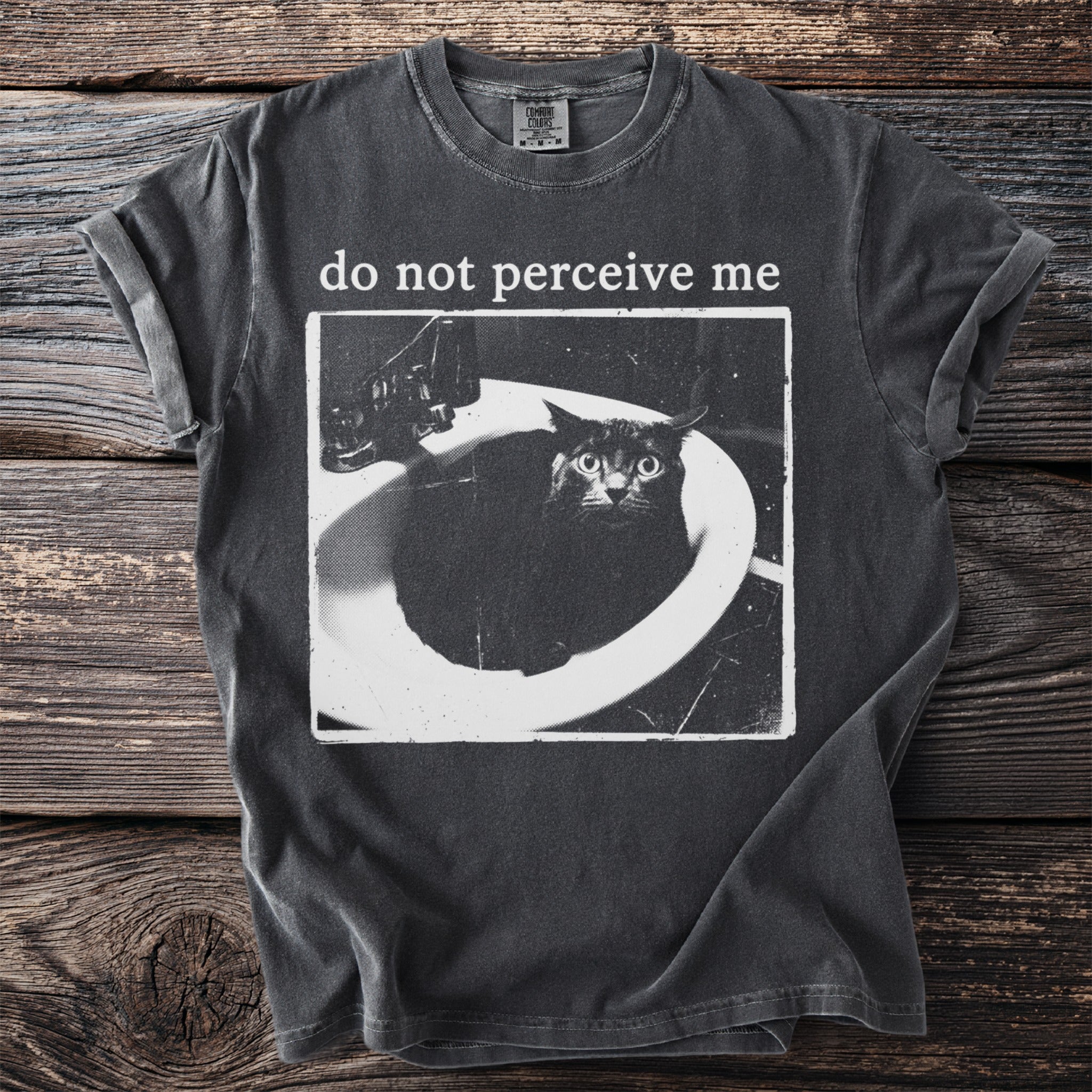 Dark t-shirt with a black cat in a sink and text "do not perceive me".