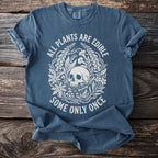 Blue t-shirt with a skull, plants, mushrooms, bones, and drug bottle design and text.