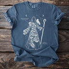Blue t-shirt featuring a white constellation figure with plants, a bird, and text.