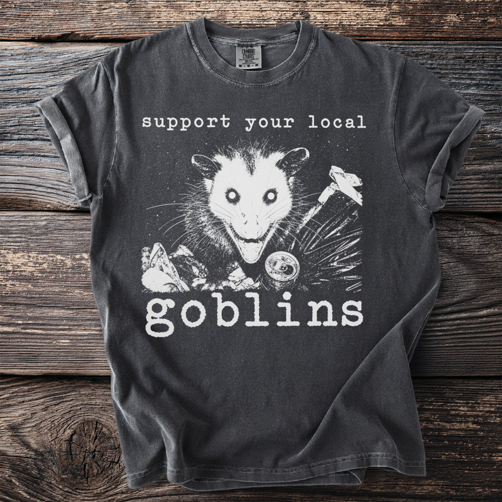 Dark grey t-shirt with opossum and text reading "support your local goblins".