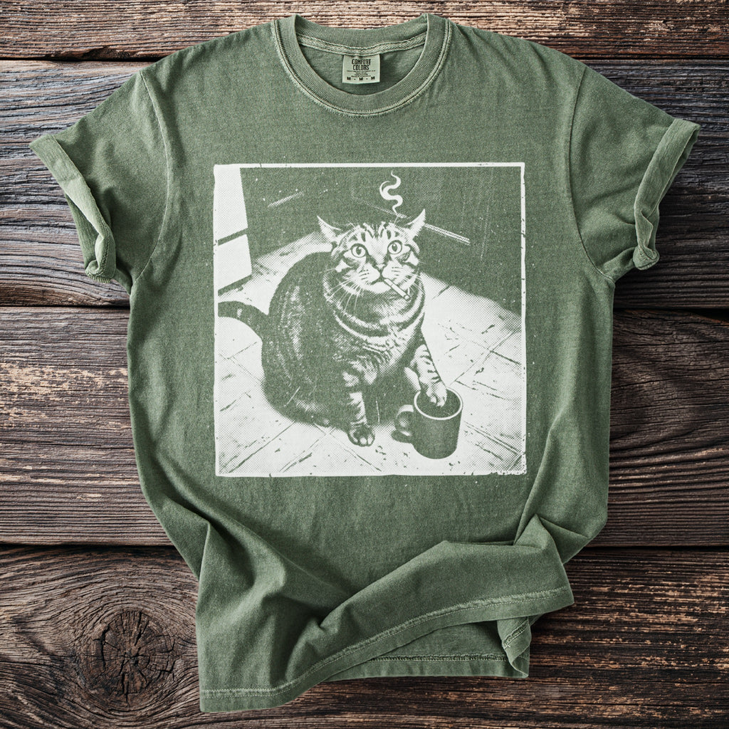Green t-shirt with a distressed graphic of a cat holding a cigarette and a coffee mug.
