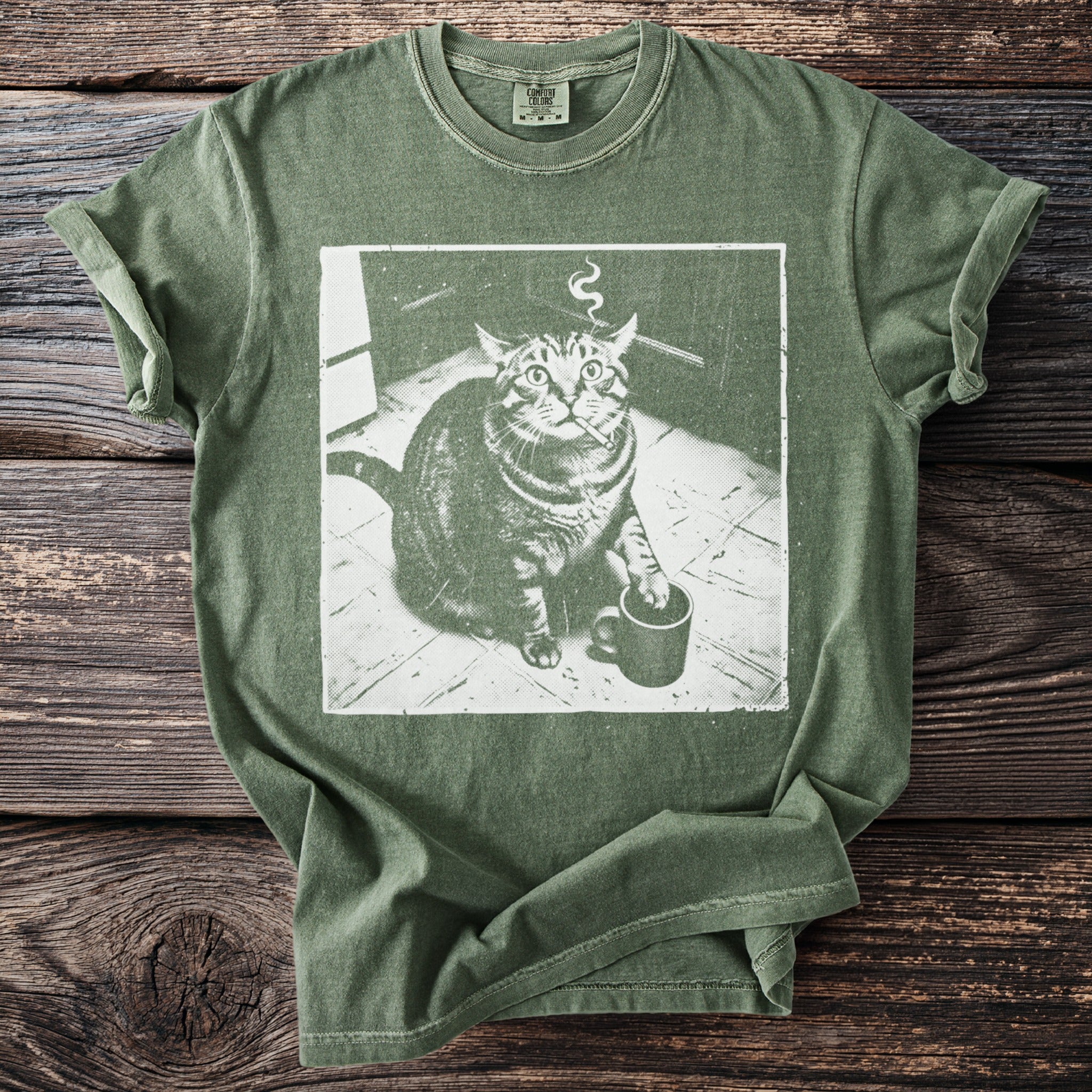 Green t-shirt with a distressed graphic of a cat holding a cigarette and a coffee mug.
