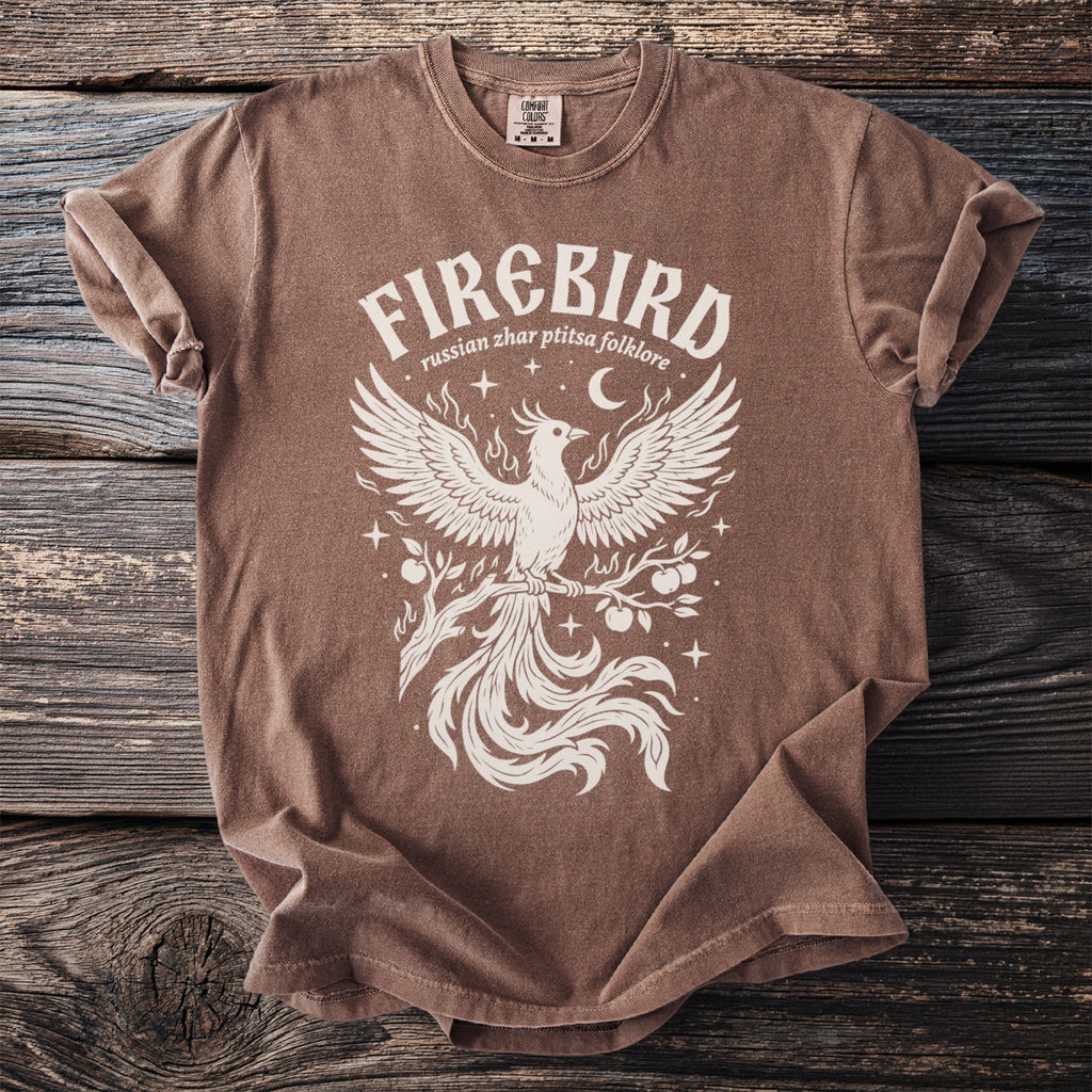 Brown t-shirt with white "Firebird russian zhar ptitsa folklore" text and phoenix graphic.