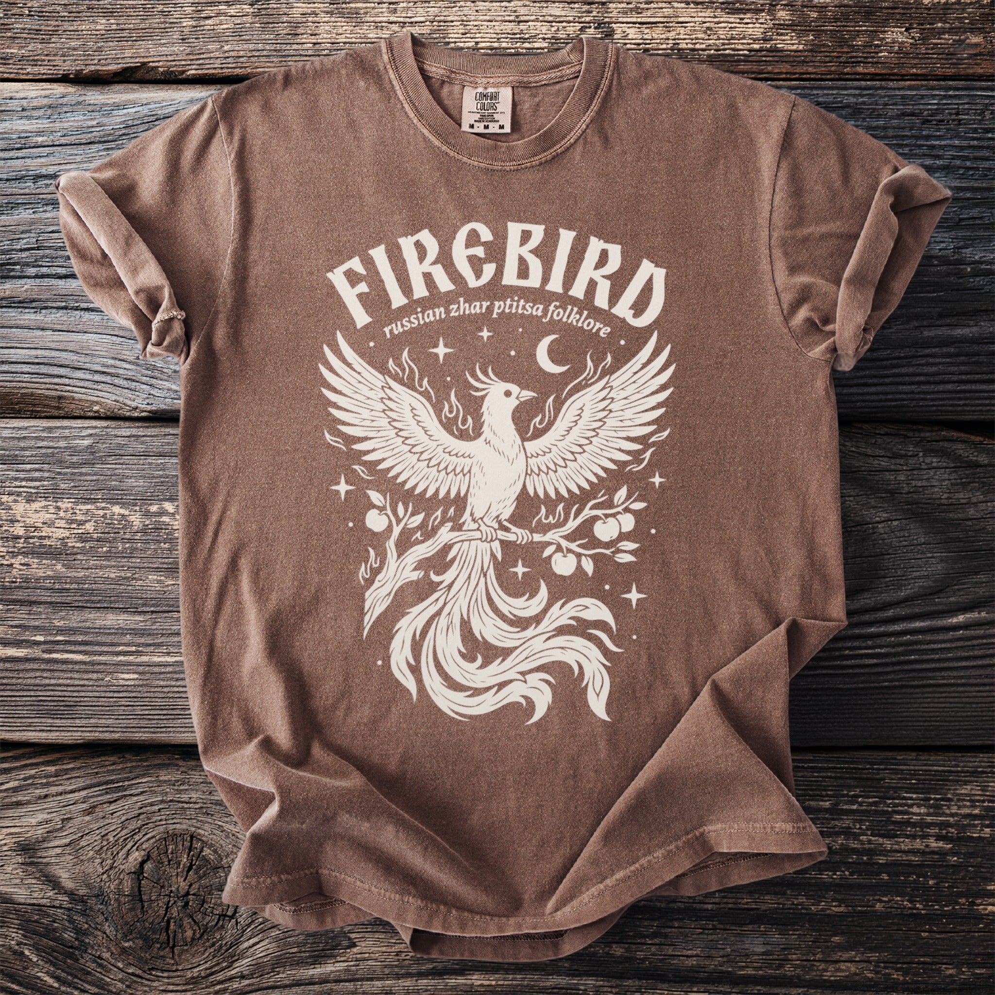 Brown t-shirt with white "Firebird russian zhar ptitsa folklore" text and phoenix graphic.