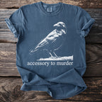 Blue t-shirt with white crow graphic and text "accessory to murder".