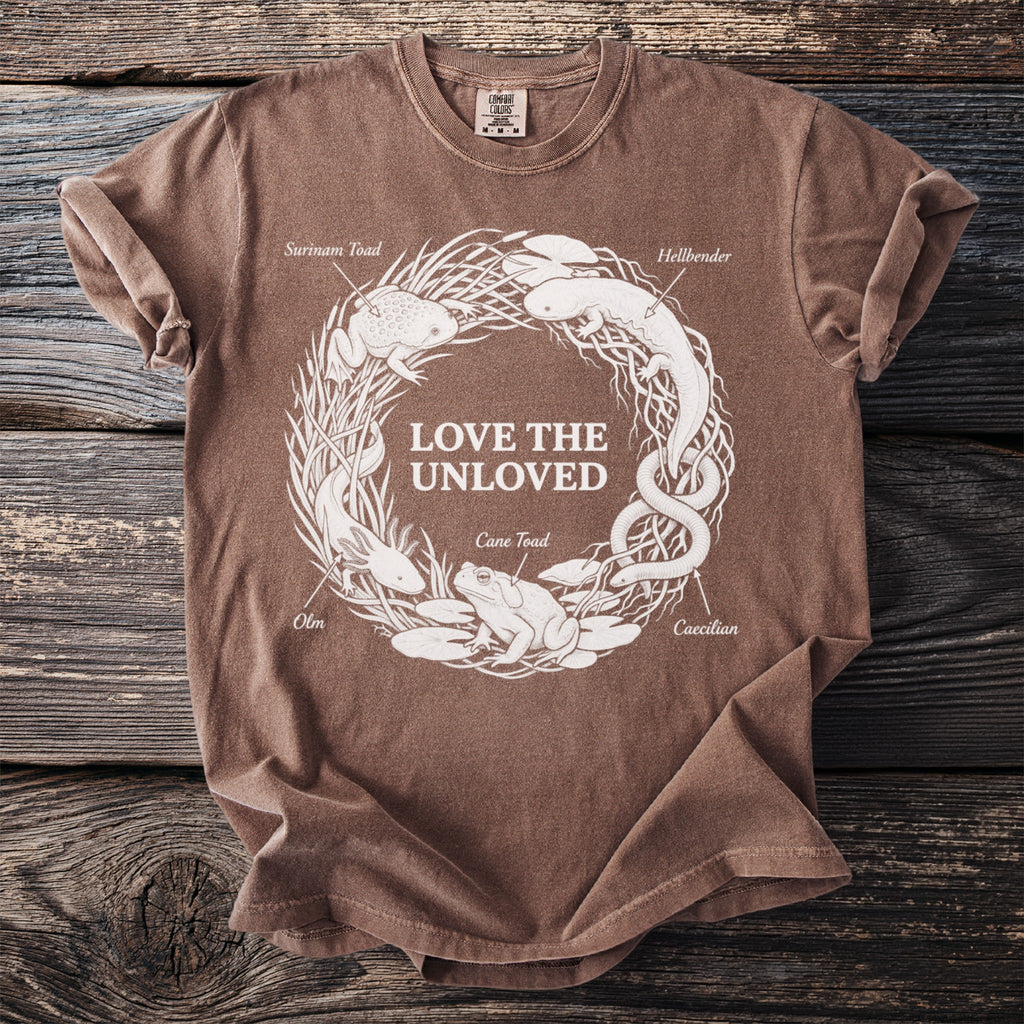 Brown t-shirt with white circular graphic of amphibians and text "LOVE THE UNLOVED".