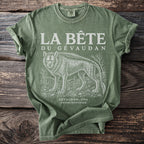 Green t-shirt with "La Bête du Gévaudan" text and wolf illustration.