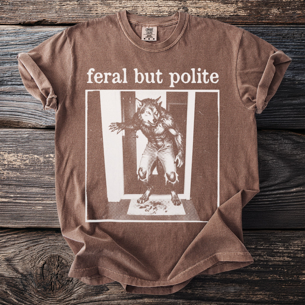 Brown t-shirt with "feral but polite" text and werewolf graphic.