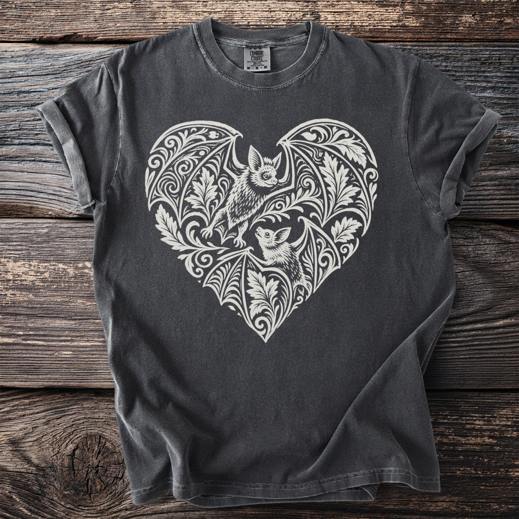 Dark gray t-shirt with a white heart-shaped bat and floral filigree design.