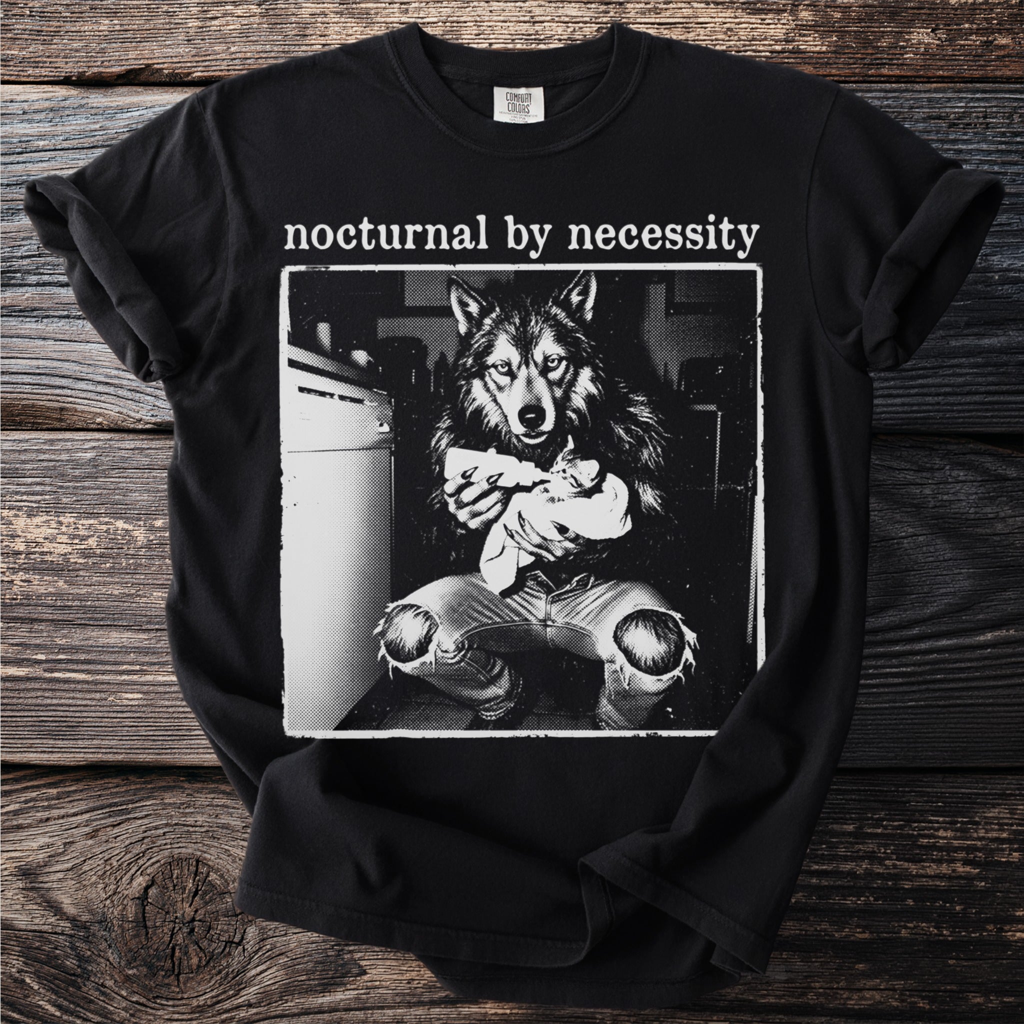 Black t-shirt with "nocturnal by necessity" and wolf holding kitten graphic.