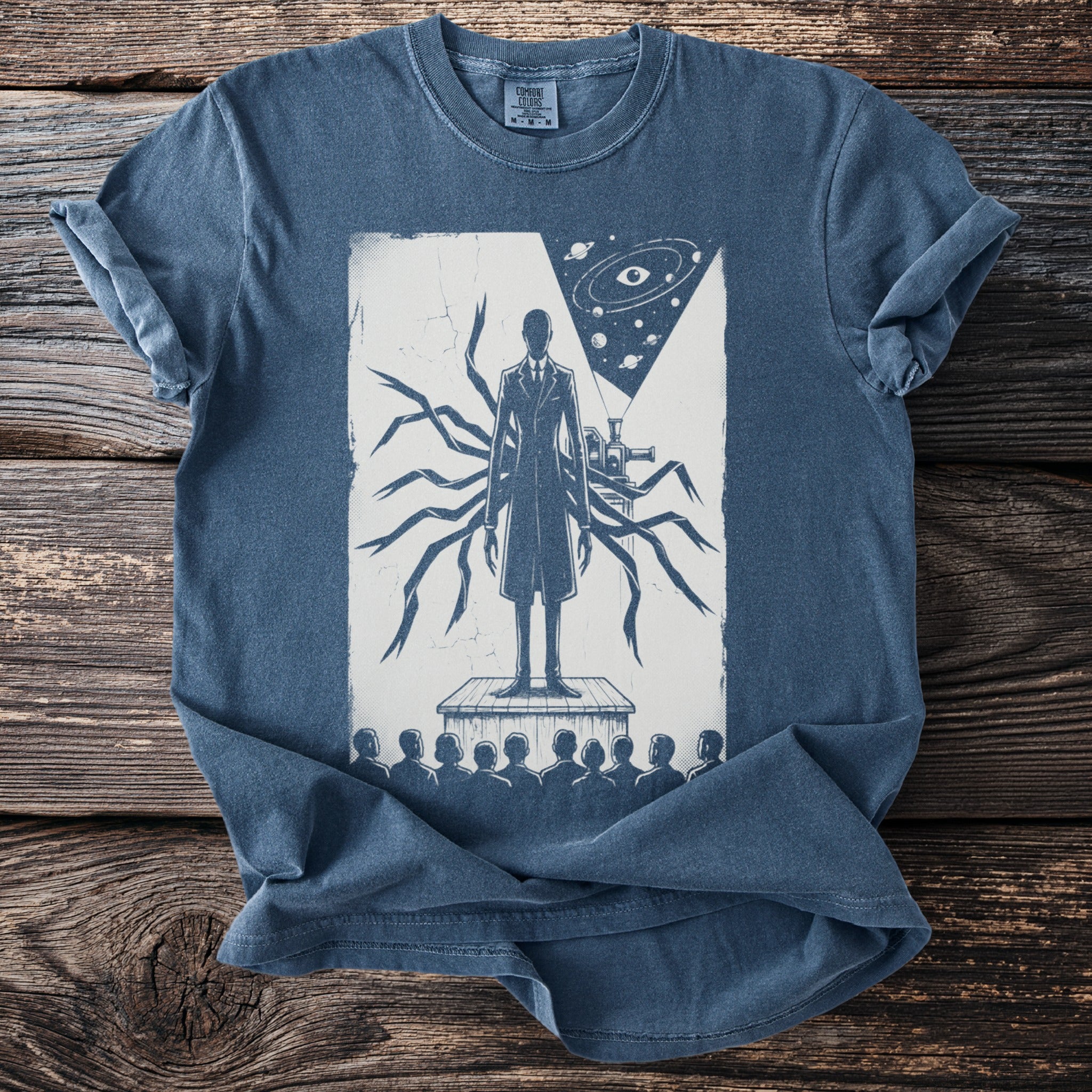 Blue t-shirt with illustration of a suit-clad figure with tentacles and a cosmic eye.