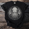 Black t-shirt with a white circular design of a tentacled face and wings.