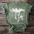 Green t-shirt with spooky girls in a cornfield and "girls will be girls" text.