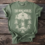 Green t-shirt featuring a graphic of "The Nine Worlds" tree with illustrated realms and names.