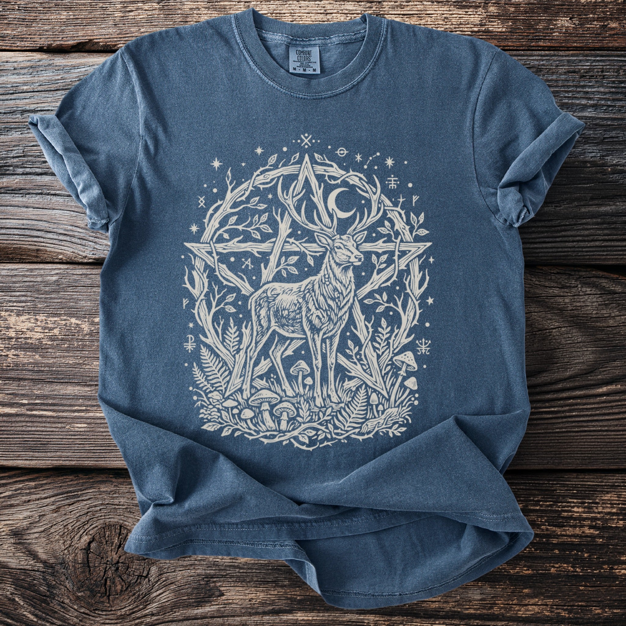 Blue t-shirt with white print of a stag within a pentagram and organic elements.
