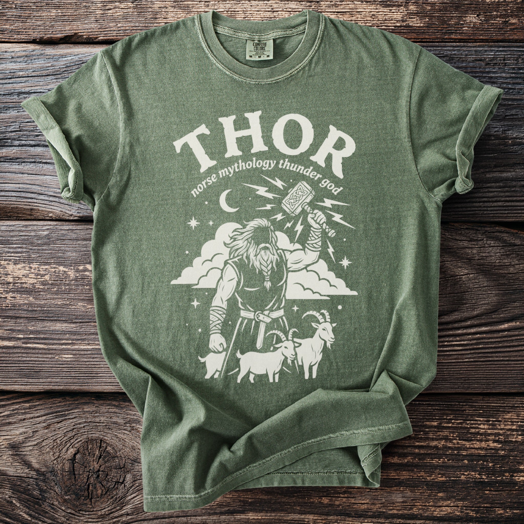 Green t-shirt with Thor, Mjolnir, goats, and lightning bolt graphic.