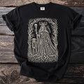 Black t-shirt with an intricate drawing of a crowned goddess, a dog, a raven and skulls.