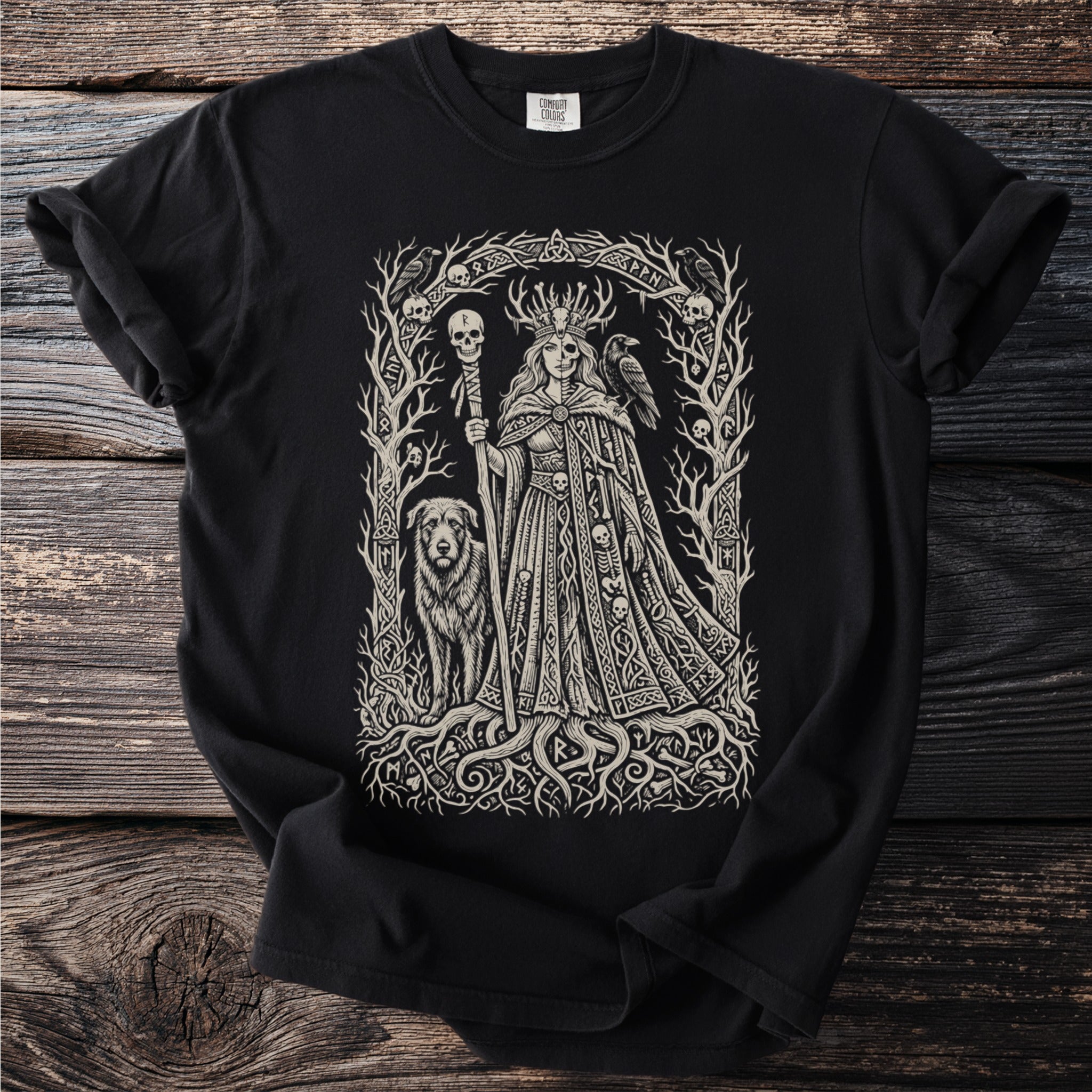 Black t-shirt with an intricate drawing of a crowned goddess, a dog, a raven and skulls.