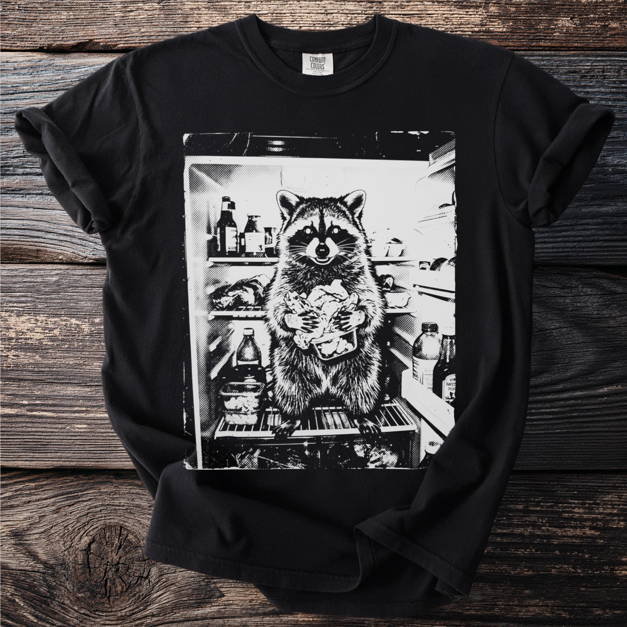Raccoon holding food inside a refrigerator filled with bottles and food items.