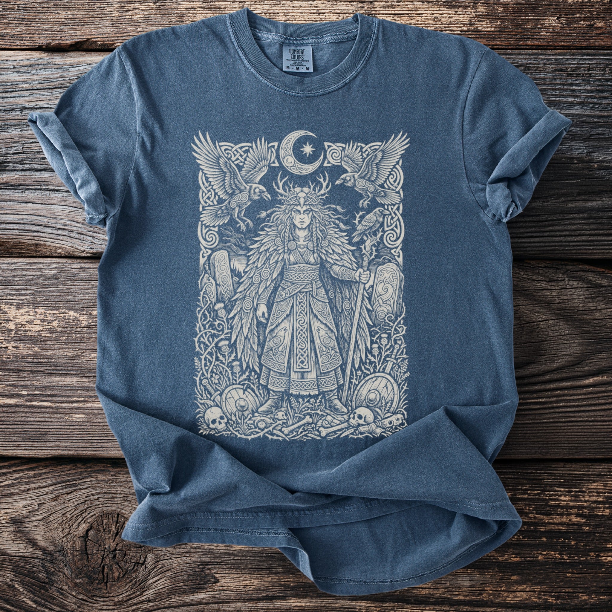 Blue t-shirt with intricate white print of a warrior queen with ravens and moon.