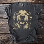 Dark grey t-shirt with gold print of a smiling dog wearing headphones on a wooden background.