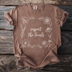 Brown t-shirt with floral border and text "respect the locals."