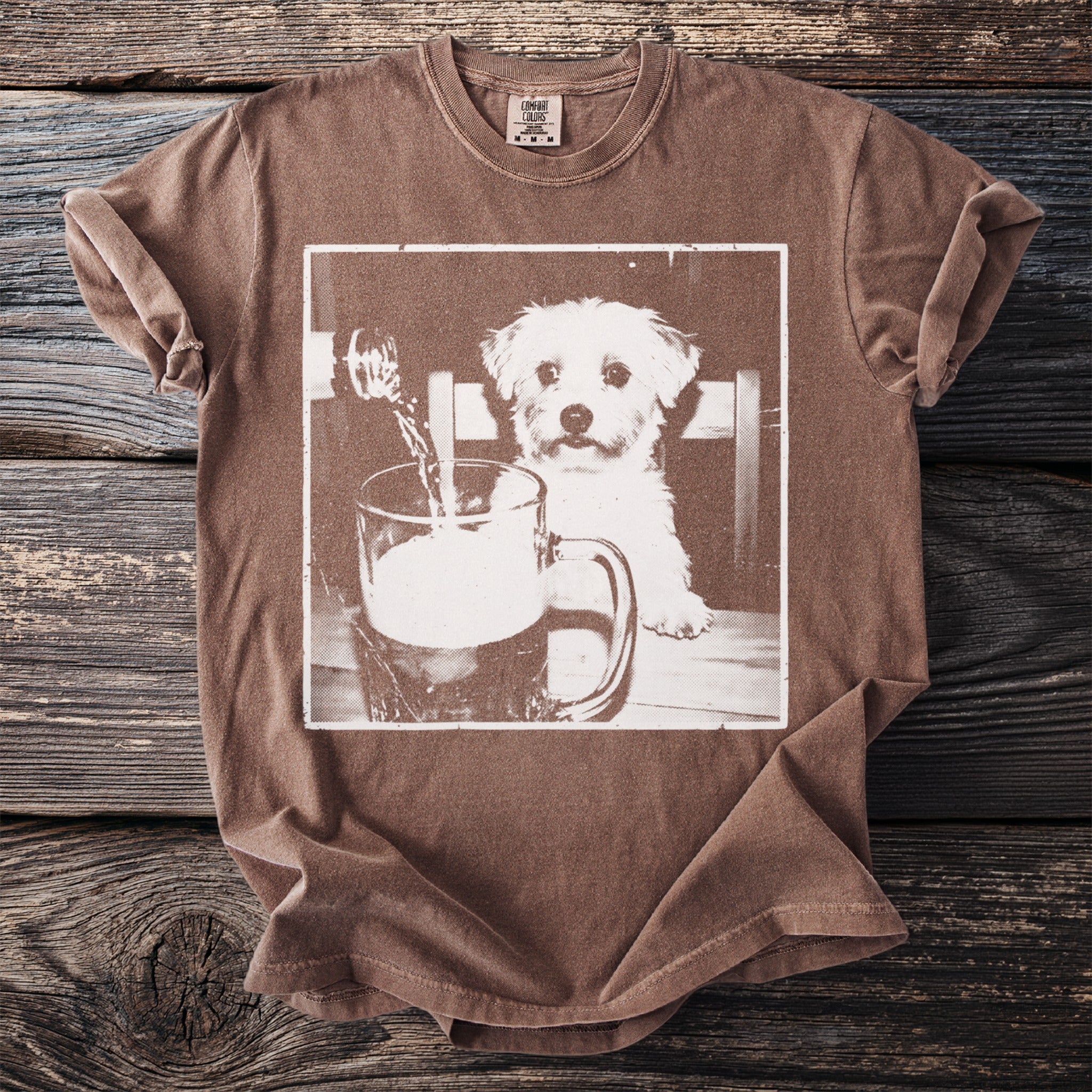 Brown t-shirt with image of a dog looking at a beer being poured into a mug.