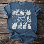Blue t-shirt with "respect the locals" and various sketched cats.