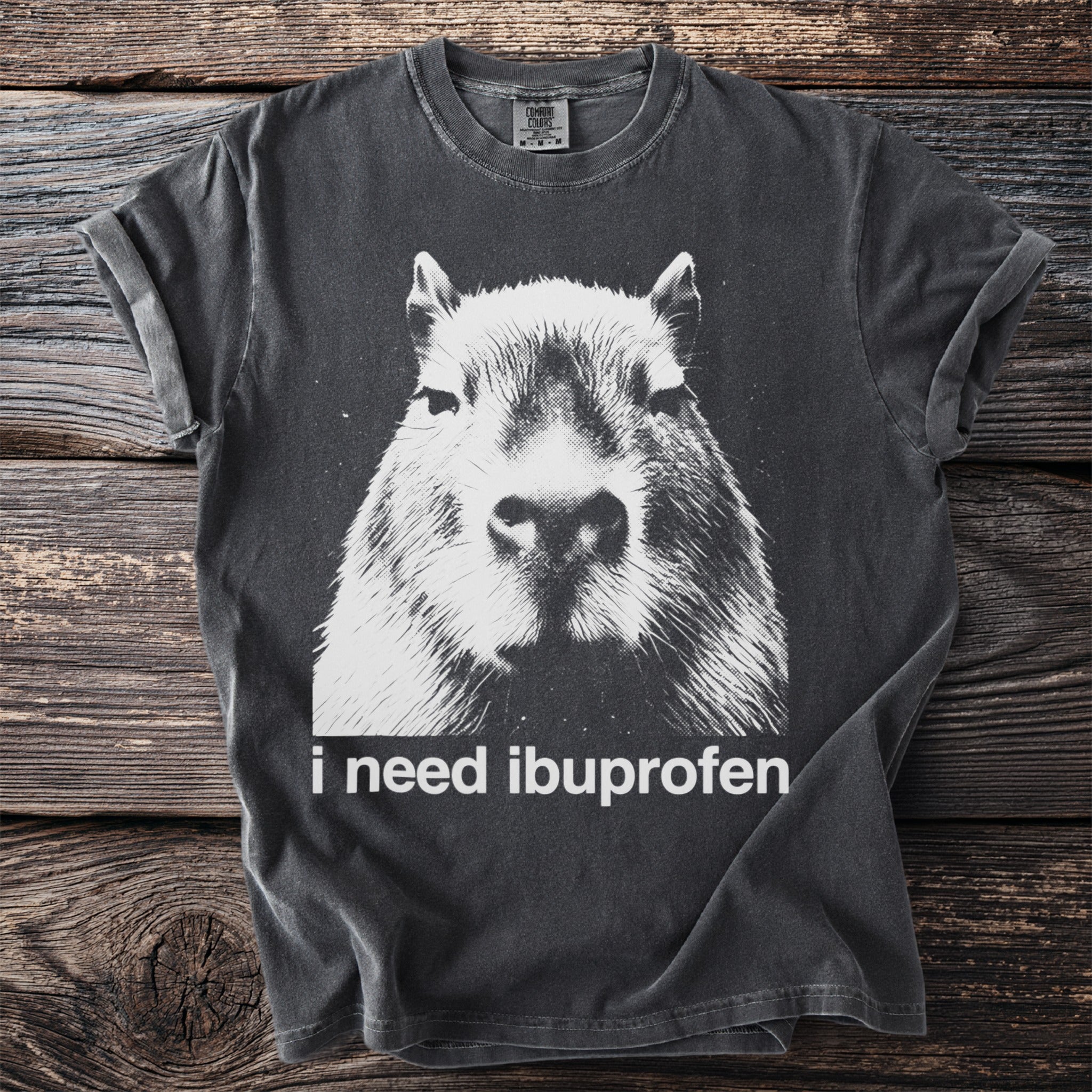 Charcoal t-shirt with capybara graphic and "i need ibuprofen" text.