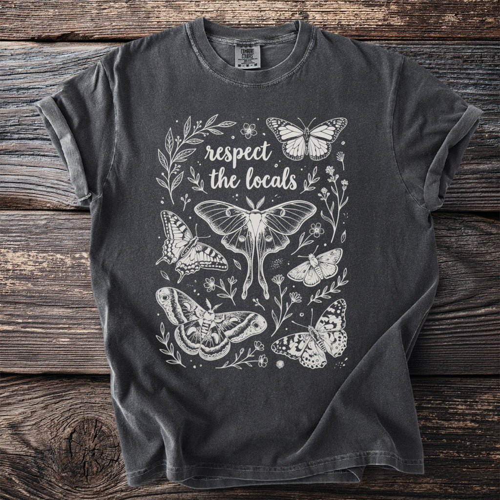 Dark grey t-shirt with white line art of butterflies and the text "respect the locals".
