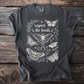 Dark grey t-shirt with white line art of butterflies and the text "respect the locals".