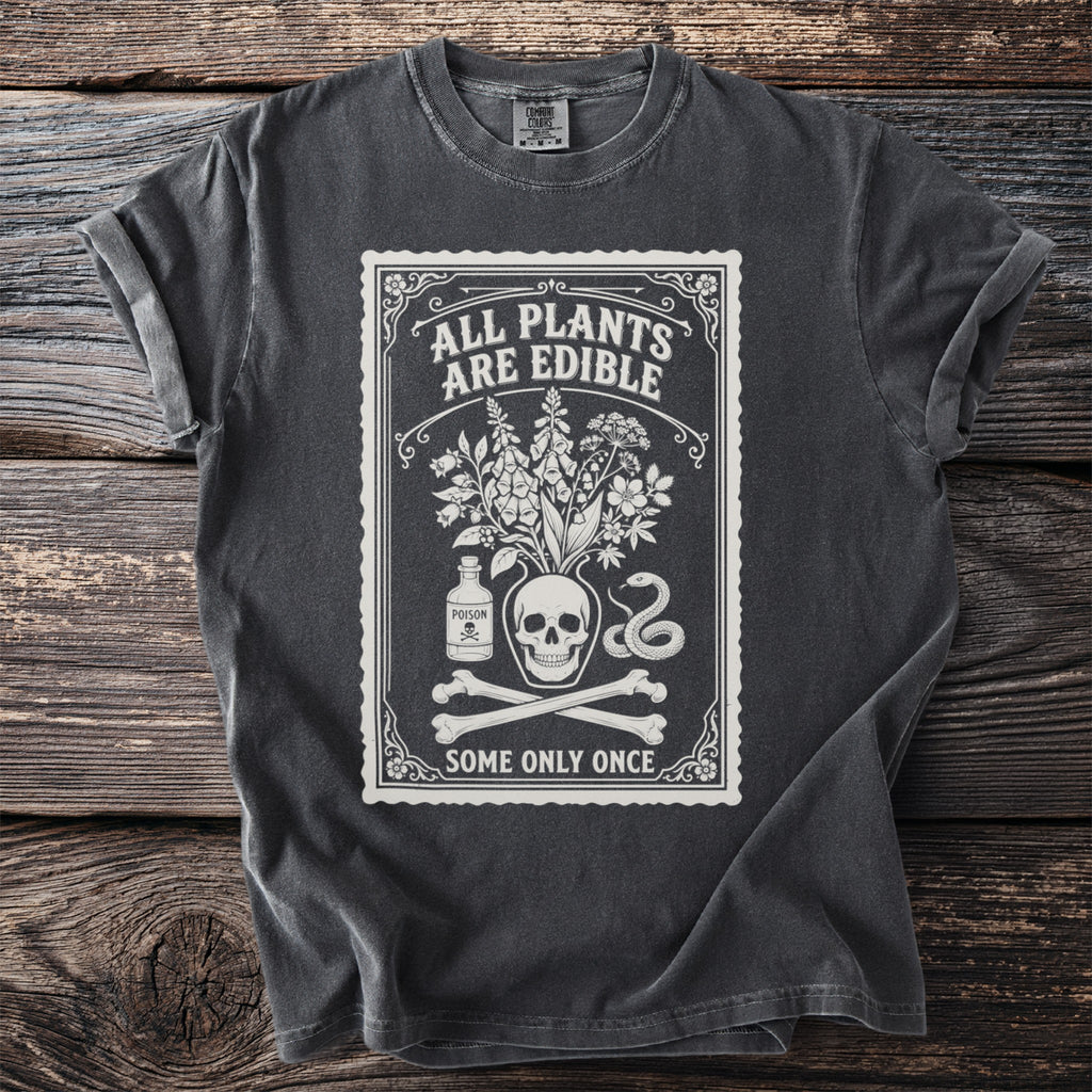 Dark grey t-shirt with a white graphic of a skull, plants, poison bottle, and snake.