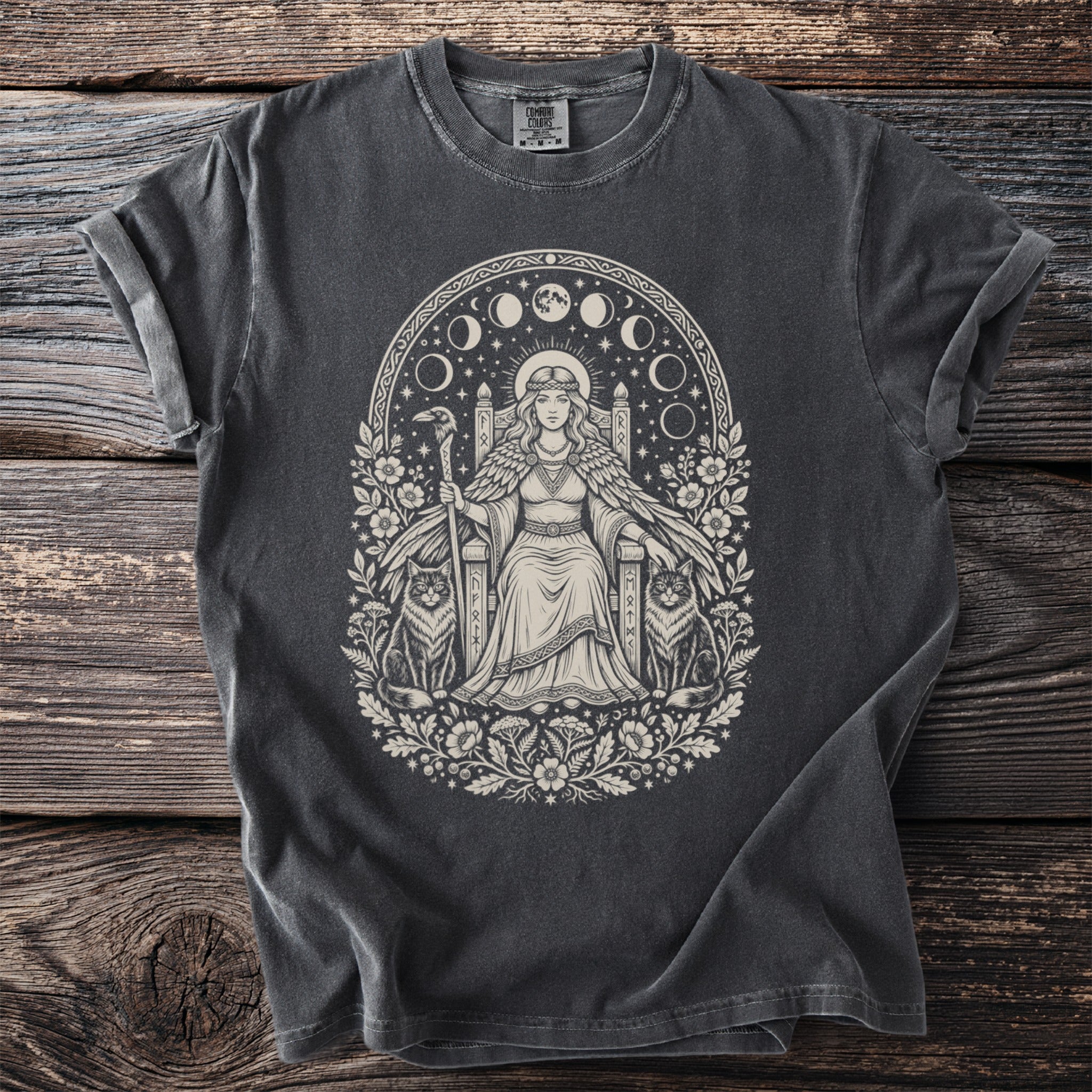 Dark gray t-shirt with a cream graphic of a queen sitting on a throne with cats and a raven.