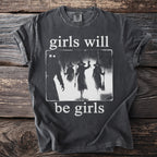 Dark t-shirt with white graphic of silhouettes of three witches and text "girls will be girls."