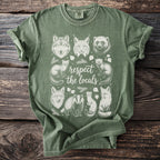 Green t-shirt with white line art of various woodland animals and "respect the locals" text.