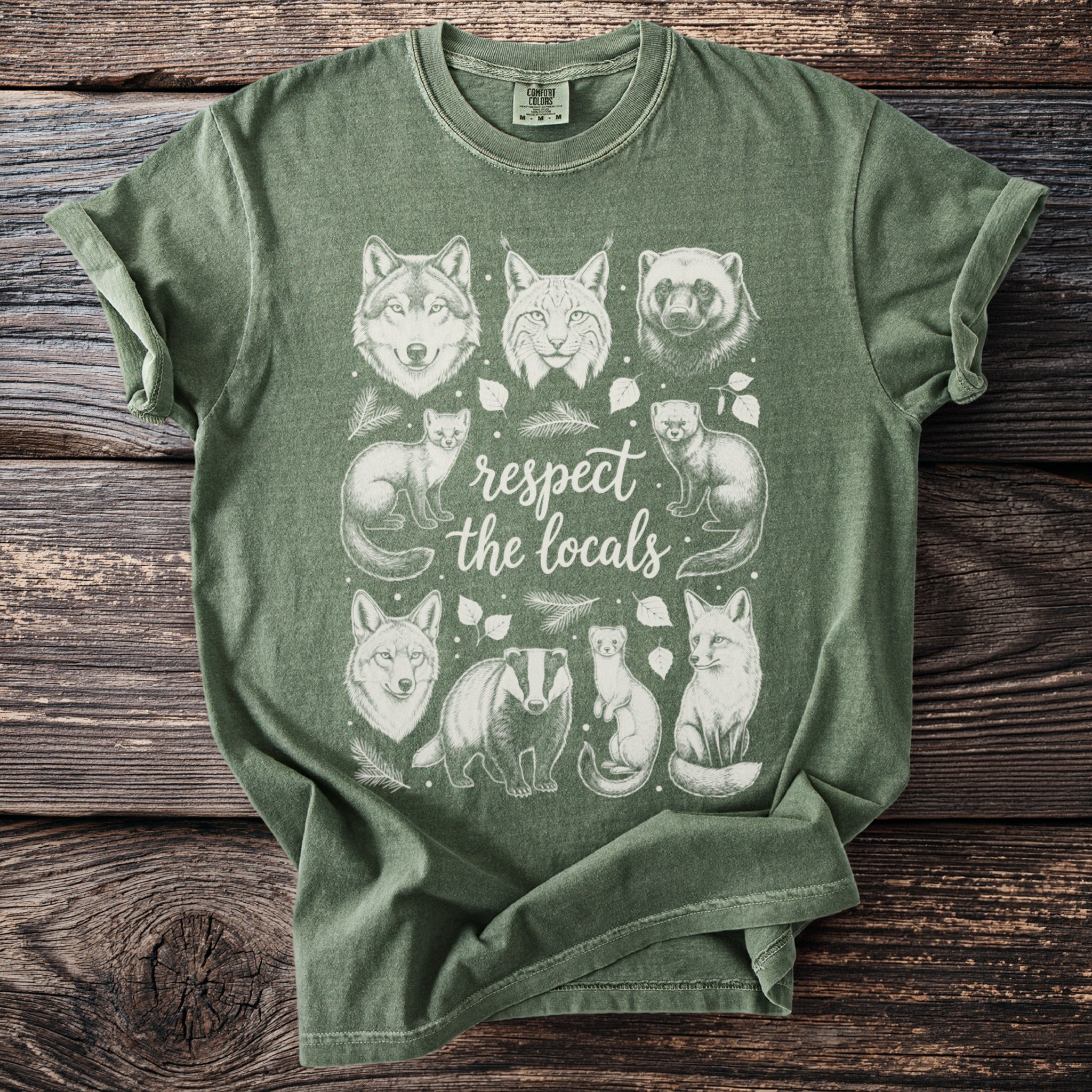 Green t-shirt with white line art of various woodland animals and "respect the locals" text.