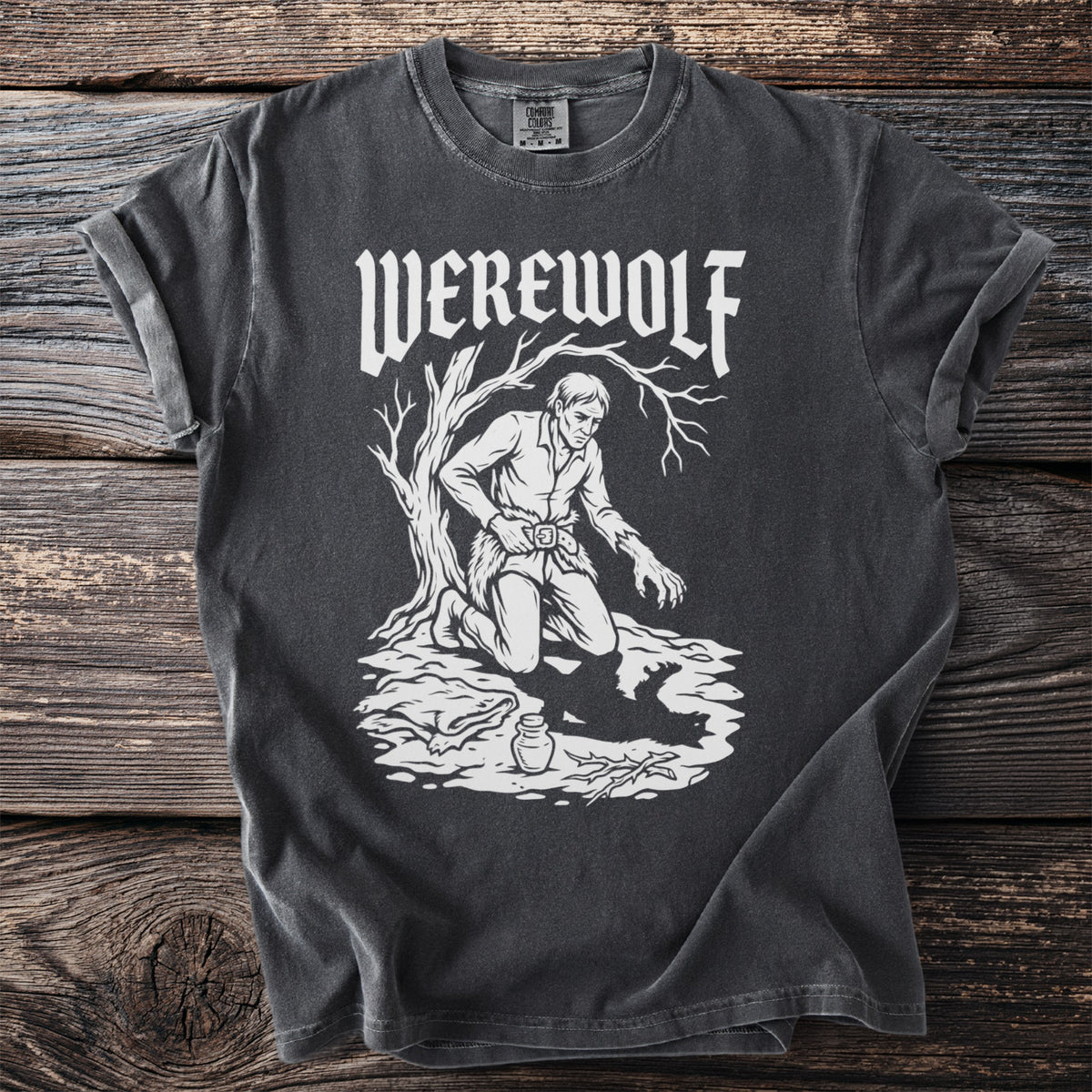 Dark t-shirt with white "WEREWOLF" text and illustration of a man transforming under a tree.