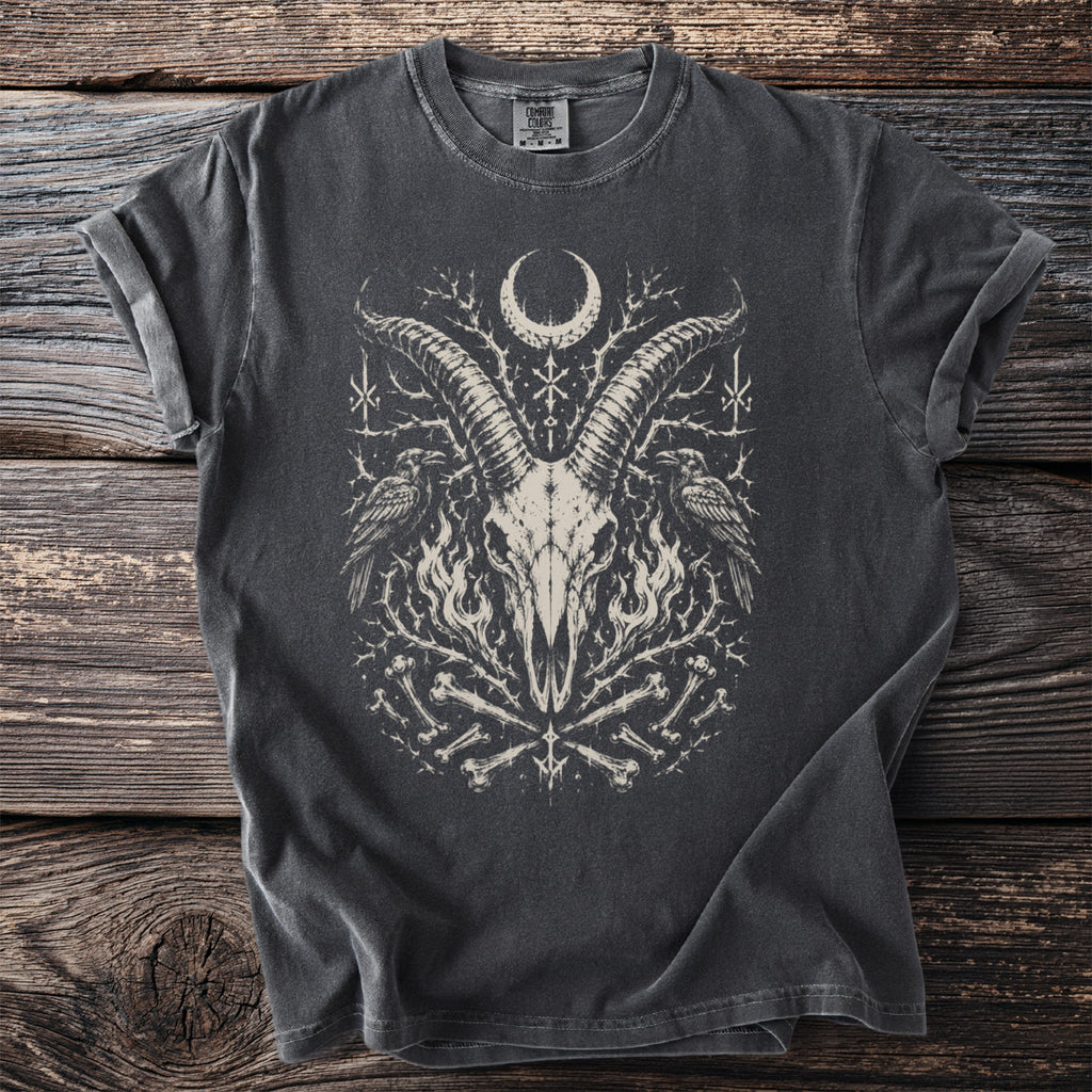 Dark t-shirt with a gothic graphic of a goat skull, ravens, moon, and bones.