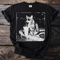 Black t-shirt with a graphic of a cat wearing sunglasses and an eyepatch drinking from a cup.