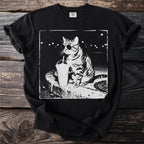 Black t-shirt with a graphic of a cat wearing sunglasses and an eyepatch drinking from a cup.