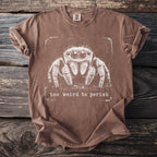 Brown t-shirt with a white graphic of a jumping spider and the text "too weird to perish".