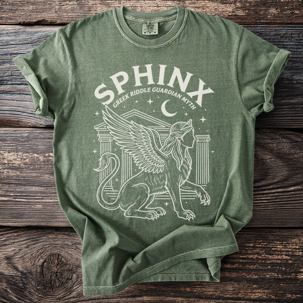 Green t-shirt with a white graphic of a winged sphinx and the text "SPHINX GREEK RIDDLE GUARDIAN MYTH".