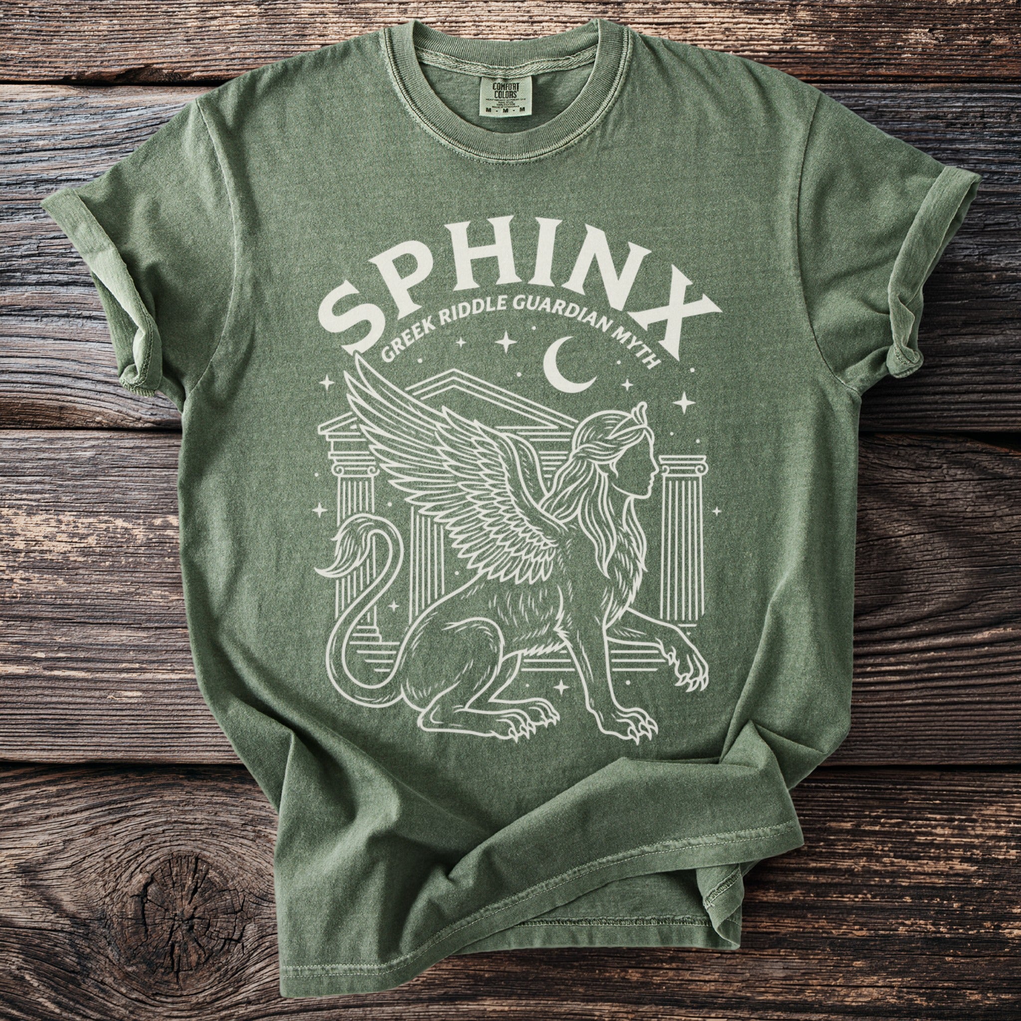Green t-shirt with a white graphic of a winged sphinx and the text "SPHINX GREEK RIDDLE GUARDIAN MYTH".