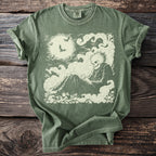 Green t-shirt with a cream-colored graphic of a skeleton sitting in clouds under a full moon.
