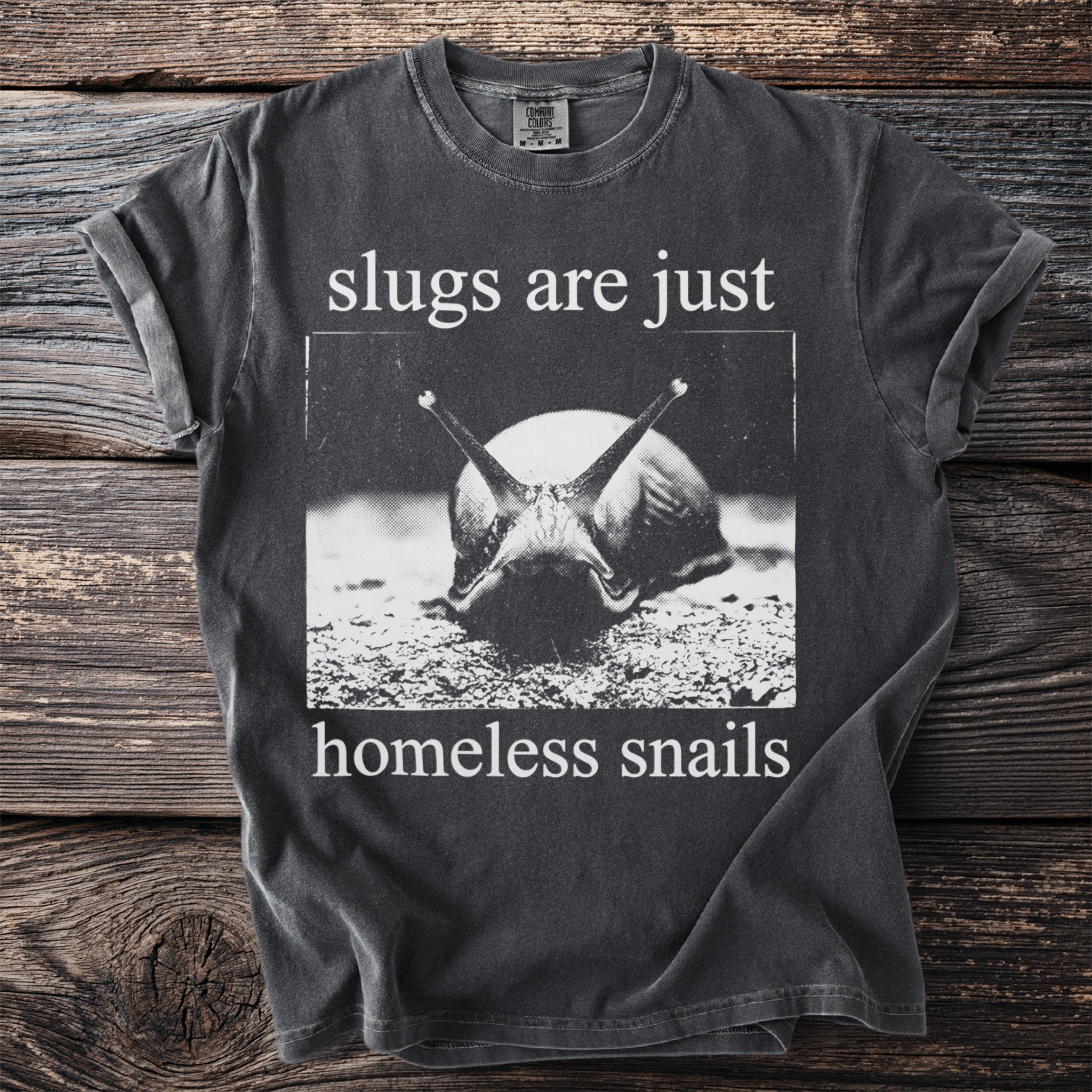Dark grey t-shirt with white text and image: "slugs are just homeless snails."